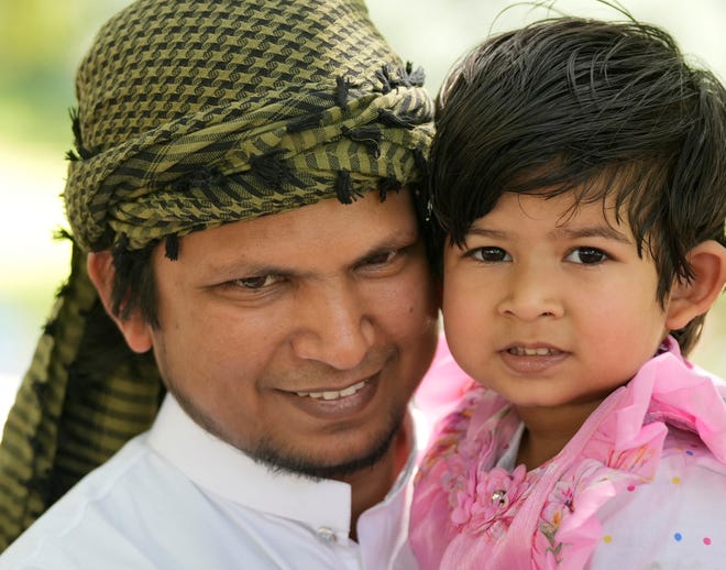 Aqueel Ansari holds his daughter Aizah Nargis, 3, at the 3rd Annual Eid Celebration and Friday Prayer at the Capitol Friday April 19, 2024. Every year after Muslims finish fasting for a month during Ramadan, they gather for Eid al-Fitr, the festival of breaking the fast. The event had Middle Eastern food, henna design, Arabic calligraphy and an art display.