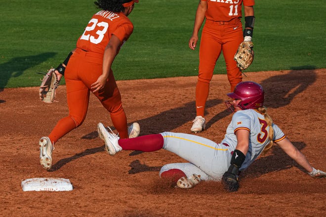 Iowa State outfielder Ireland Buss (3) slides into second after a missed catch by Texas Longhorns short stop Viviana Martinez (23) during the game at Red and Charline McCombs Field on Friday, April 26, 2024 in Austin.