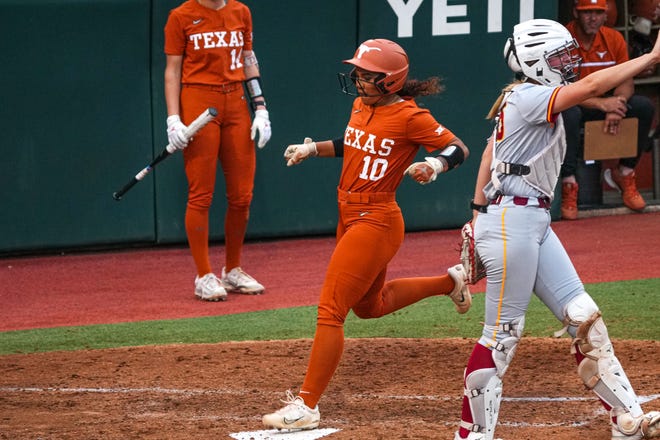 Texas Longhorns player Mia Scott (10) runs in for a sccore after a hit by Ashton Maloney (7) during the game against Iowa State at Red and Charline McCombs Field on Friday, April 26, 2024 in Austin.
